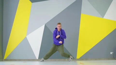 Young guy dancing hip hop, modern youth dance free style in the studio Stock Footage 139757305
