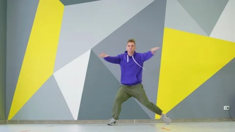 Young guy dancing hip hop, modern youth dance free style in the studio Stock Footage 139757344