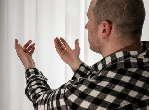 Young guy in a dancing pose on a white background. Modern dance in a plaid .. Stock Photos