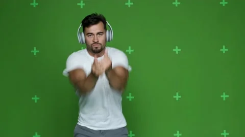 Young guy dancing rhythmically looking into the camera Stock Footage 130831284