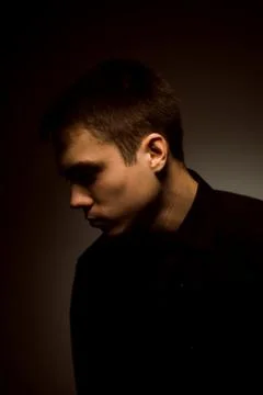 Young guy on a dark studio background Stock Photos