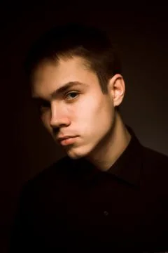 Young guy on a dark studio background Stock Photos