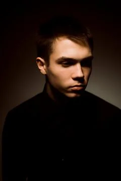 Young guy on a dark studio background Stock Photos