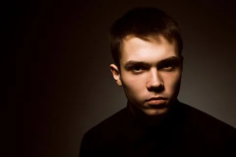 Young guy on a dark studio background Stock Photos