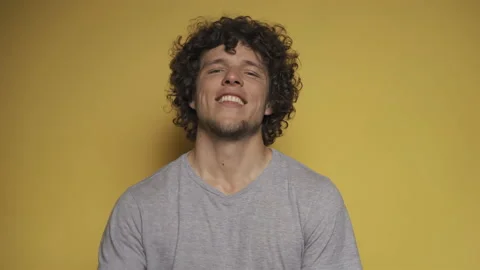 Young guy defiantly calls to himself, and then gestures to ask to move away from Stock Footage 142213723