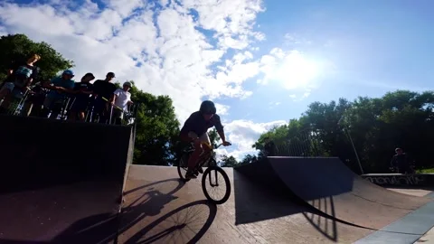 A young guy does tricks on a bicycle at a skatepark in Sumy, Ukraine Stock Footage 276904105
