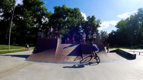 A young guy does tricks on a bicycle at a skatepark in Sumy, Ukraine Stock Footage 276904971
