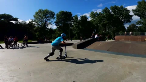A young guy does tricks on a scooter in a skatepark in Sumy, Ukraine Stock Footage 276904138