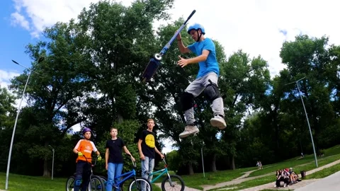 A young guy does tricks on a scooter in a skatepark in Sumy, Ukraine Stock Footage 276904524