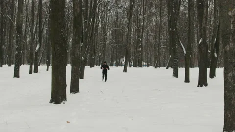 Young guy doing a run in the winter forest Stock Footage 111153381