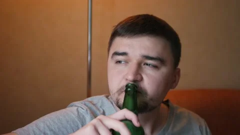 Young guy drinking nice beer with smile savoring every sip after work 스톡 동영상 197079199