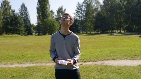 Young guy drives the Quad, looking up. Zoom out, outdoor, natural light, the Gen Stock Footage 84913411