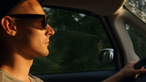 Young guy is driving and looking forward Video stock 80044499
