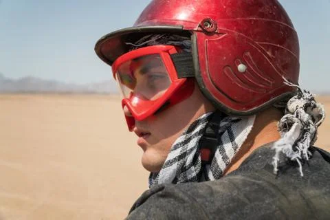 Young guy during desert excursion by quad - Man in helmet and adventure cloth Stock Photos
