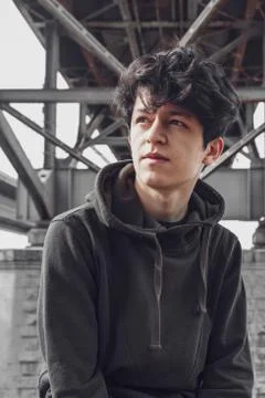 A young guy of Eastern appearance with black hair and a handsome expressive face Stock Photos