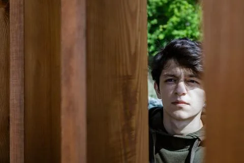 A young guy of Eastern appearance with black hair and a handsome expressive face Stock Photos