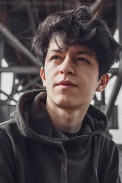 A young guy of Eastern appearance with black hair and a handsome expressive face Stock Photos