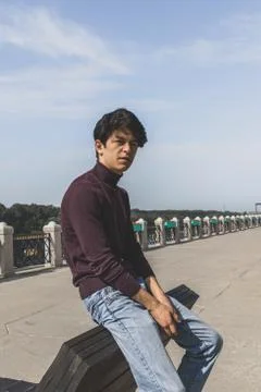 A young guy of Eastern appearance with black hair and a handsome expressive face Stock Photos