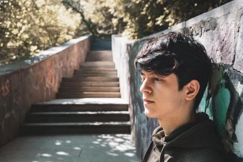 A young guy of Eastern appearance with black hair and a handsome expressive face Stock Photos