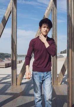 A young guy of Eastern appearance with black hair and a handsome expressive face Stock Photos