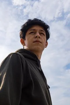 A young guy of Eastern appearance with black hair and a handsome expressive face Stock Photos