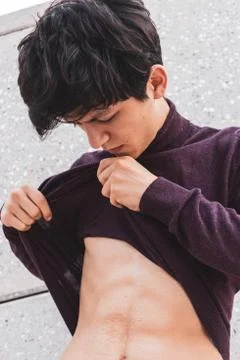 A young guy of Eastern appearance with black hair and a handsome expressive face Stock Photos