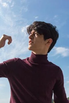 A young guy of Eastern appearance with black hair and a handsome expressive face 스톡 사진