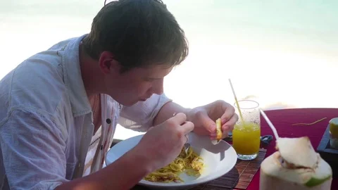 A young guy is eating out on the terrace. outdoors. Italian cuisine Video stock 75997497