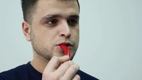 Young guy eats pepper chilly Stock Footage 85020345