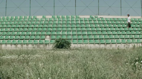 Young guy in an empty stadium Stock Footage 132219152
