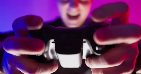 Young Guy Enthusiastically Playing in Video Games on TV Console. Stock Footage 150749725