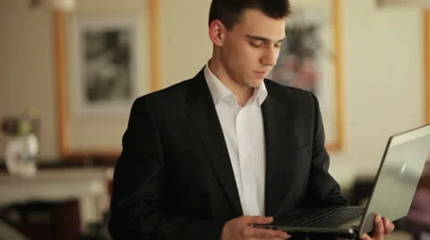 Young guy finished work with a laptop Stock Footage 22769691