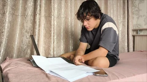 A young guy is flipping through the pages of a document Video stock 311653911