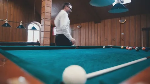 Young guy gets angry and rolls balls on the table Stock Footage 81476609