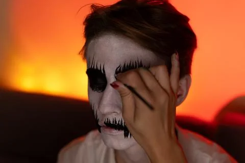 A young guy gets makeup for the Halloween holiday. 스톡 사진