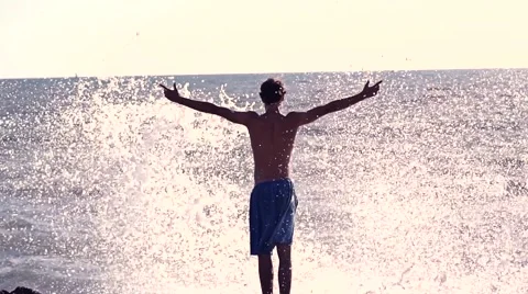 Young Guy getting hit by Wave Stock Footage 53255594