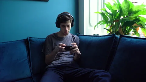 Young Guy getting a Small Victory on Mobile Game Stock Footage 274192573