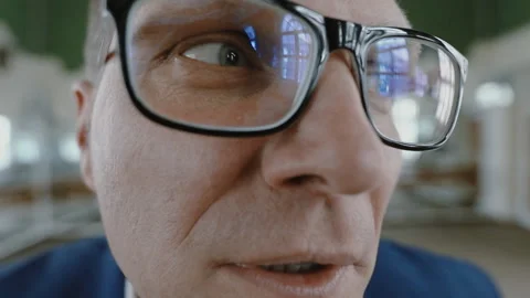 A young guy with glasses funny and emotional looks and speaks into the lens of Stock Footage 151485529