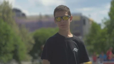 Young guy with glasses looks at the camera Stock Footage 81811366