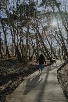 Young guy goes forward along the path in the park 写真素材