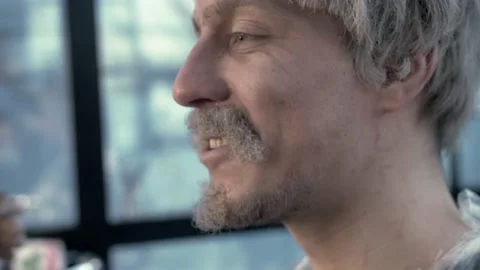 Young guy in a gray wig with a beard and mustache gets makeup before shooting Stock Footage 136154541