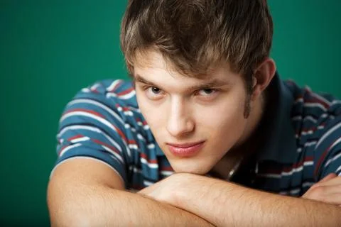Young guy on a green background 스톡 사진