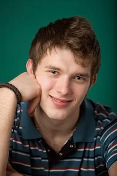 Young guy on a green background 스톡 사진