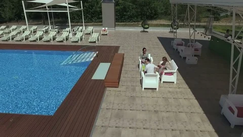 Young guy greets his friends near a swimming pool Stock Footage