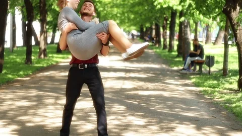 Young  guy happily and romantically picking up a young woman. Vidéo 92336600