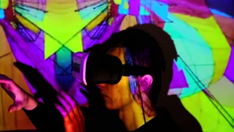 Young guy has fun, shows a finger to the side and laughs Man watches and using V Stock Footage 130176410