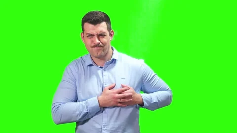 Young guy has a heart condition heart attack heart hurts green screen Vidéo 235943634