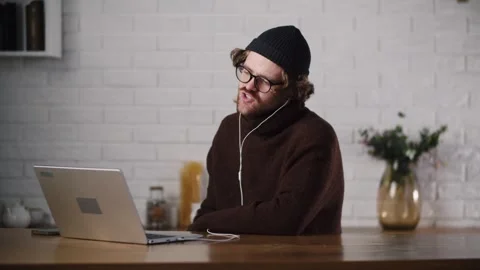 A young guy have video call, or meeting, doing his job. It freelancer work Stock Footage 264404790
