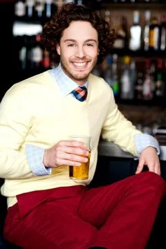 Young guy having chilled beer at bar Stock Photos