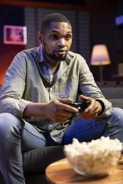 Young guy having fun with video games on television modern setup 스톡 사진